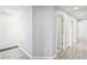 Hallway featuring white trim, doors, and modern vinyl flooring at 11301 Hudson Hills Ln, Riverview, FL 33579