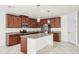 Well-lit kitchen featuring dark wood cabinets, granite countertops, and stainless steel appliances at 11301 Hudson Hills Ln, Riverview, FL 33579