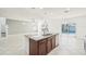 Open kitchen features granite counters, an island with a sink, and backyard views at 11301 Hudson Hills Ln, Riverview, FL 33579