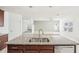 Kitchen island with double sink and granite countertops at 11301 Hudson Hills Ln, Riverview, FL 33579