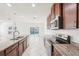 Bright kitchen features granite countertops, stainless steel appliances, and backyard views at 11301 Hudson Hills Ln, Riverview, FL 33579