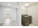 Convenient laundry room featuring modern washer and dryer, plus overhead shelving for storage and organization at 11301 Hudson Hills Ln, Riverview, FL 33579