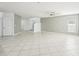Open living area with tile flooring, a ceiling fan, and a staircase leading to the upper level at 11301 Hudson Hills Ln, Riverview, FL 33579