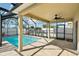 Screened-in pool with a covered patio, fan, and tiled decking at 11301 Hudson Hills Ln, Riverview, FL 33579