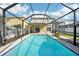 Backyard pool with screened-in enclosure, patio, and landscaping at 11301 Hudson Hills Ln, Riverview, FL 33579