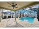 Relaxing screened-in pool area with stone-paved patio and outdoor ceiling fan at 11301 Hudson Hills Ln, Riverview, FL 33579