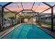 Inviting screened pool with string lights, perfect for evening relaxation and outdoor enjoyment at 11301 Hudson Hills Ln, Riverview, FL 33579