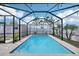 Inviting in-ground pool with a screened enclosure, surrounded by a paved patio area, perfect for outdoor enjoyment at 11301 Hudson Hills Ln, Riverview, FL 33579