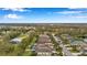 Overhead view of a suburban neighborhood with well-kept properties, green lawns, and a charming lakeside at 11822 Crawford Parrish Ln, Parrish, FL 34219