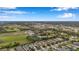 Expansive aerial view of a residential neighborhood interspersed with ponds, trees, and green spaces at 11822 Crawford Parrish Ln, Parrish, FL 34219