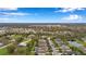 Wide aerial view capturing a Gathering-friendly community with houses nestled among trees and a scenic pond at 11822 Crawford Parrish Ln, Parrish, FL 34219