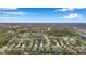 Lovely aerial view of a modern community with attractive homes, picturesque ponds, and tree-lined streets at 11822 Crawford Parrish Ln, Parrish, FL 34219