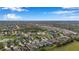 Aerial perspective of a sprawling residential development with tree-lined streets, ponds, and Gathering homes at 11822 Crawford Parrish Ln, Parrish, FL 34219