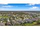 Expansive aerial view of a residential area featuring tidy homes, tree-lined streets, and a serene environment at 11822 Crawford Parrish Ln, Parrish, FL 34219