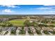 Picturesque aerial shot of houses in a quiet community, showcasing landscaping and nearby green spaces at 11822 Crawford Parrish Ln, Parrish, FL 34219