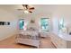 Bright bedroom with windows, ceiling fan, and light colored flooring at 11822 Crawford Parrish Ln, Parrish, FL 34219