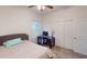 Bedroom featuring a cozy bed, a functional desk area, and ample closet space at 11822 Crawford Parrish Ln, Parrish, FL 34219