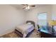 Cozy bedroom with neutral carpet, a ceiling fan, a window, and a work space at 11822 Crawford Parrish Ln, Parrish, FL 34219