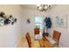 Bright dining room features wicker chairs, glass table, and decorative wall art at 11822 Crawford Parrish Ln, Parrish, FL 34219