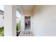 Welcoming foyer showcasing a glimpse of the home's interior with hardwood floors and stylish furnishings at 11822 Crawford Parrish Ln, Parrish, FL 34219