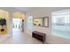 Bright foyer features wood floors, arched doorway, large mirror, and entry view at 11822 Crawford Parrish Ln, Parrish, FL 34219