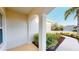 A cozy front porch framed by elegant columns and lush landscaping that enhances the curb appeal at 11822 Crawford Parrish Ln, Parrish, FL 34219