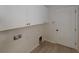 Efficient laundry room with overhead cabinets and readily available hookups for washer and dryer at 11822 Crawford Parrish Ln, Parrish, FL 34219