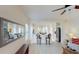 Bright, open living space with breakfast bar, stainless appliances, and tiled flooring at 11822 Crawford Parrish Ln, Parrish, FL 34219