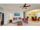 Living room with ceiling fan featuring a sofa, glass table, and adjacent dining area at 11822 Crawford Parrish Ln, Parrish, FL 34219