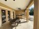 Outdoor kitchen with grill, sink, and seating area perfect for entertaining by the pool at 11822 Crawford Parrish Ln, Parrish, FL 34219