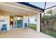 Enjoy the screened-in patio, complete with comfortable seating and a serene view of the backyard at 11822 Crawford Parrish Ln, Parrish, FL 34219