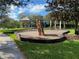 Community playground featuring wood chip ground cover, varied play structures, and shaded seating for parents and children to enjoy at 11822 Crawford Parrish Ln, Parrish, FL 34219