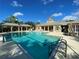 Large swimming pool area featuring comfortable lounge chairs and a well-maintained deck for residents to enjoy at 11822 Crawford Parrish Ln, Parrish, FL 34219