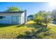 Side view of the house showing a green lawn and nice landscaping at 13116 Sheridan Dr, Hudson, FL 34667