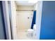Clean bathroom with a white tile shower, and blue accents at 13116 Sheridan Dr, Hudson, FL 34667