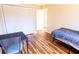 Cozy bedroom featuring wood floors, bi-fold closet doors and plenty of natural light at 13116 Sheridan Dr, Hudson, FL 34667