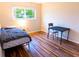 Bedroom featuring wood flooring, bed, a nightstand and views from the window at 13116 Sheridan Dr, Hudson, FL 34667