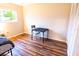 Bright bedroom featuring wood floors and a large window offering plenty of natural light at 13116 Sheridan Dr, Hudson, FL 34667