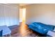 Bright bedroom with wood flooring, closet, and view into doorway at 13116 Sheridan Dr, Hudson, FL 34667