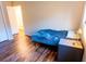 Bedroom featuring wood flooring, closet, and view into doorway at 13116 Sheridan Dr, Hudson, FL 34667