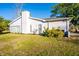 Exterior side view of the home featuring well-maintained lawn and landscaping at 13116 Sheridan Dr, Hudson, FL 34667