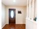 Bright foyer featuring hardwood floors, a stylish front door, and coat rack at 13116 Sheridan Dr, Hudson, FL 34667