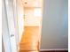Hallway view with closet leading to additional living space and wood floors at 13116 Sheridan Dr, Hudson, FL 34667