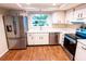 This bright kitchen features stainless steel appliances, wood floors and a window overlooking the front yard at 13116 Sheridan Dr, Hudson, FL 34667