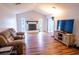 Spacious living room featuring a fireplace, wood floors, and ample natural light at 13116 Sheridan Dr, Hudson, FL 34667