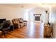 Comfortable living room featuring wood floors, a cozy couch, and entertainment center at 13116 Sheridan Dr, Hudson, FL 34667