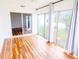 Bright sunroom featuring wood floors, ceiling fan, and large sliding glass doors at 13116 Sheridan Dr, Hudson, FL 34667
