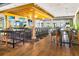Spacious bar interior with tall ceilings, exposed wooden beams, bar seating and tables at 13823 Messina Loop # 204, Bradenton, FL 34211