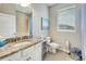 Well-lit bathroom with a granite vanity top, and modern fixtures at 13823 Messina Loop # 204, Bradenton, FL 34211