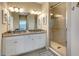 Bathroom showcasing double vanity, granite countertops, framed decor, and a glass-enclosed shower at 13823 Messina Loop # 204, Bradenton, FL 34211